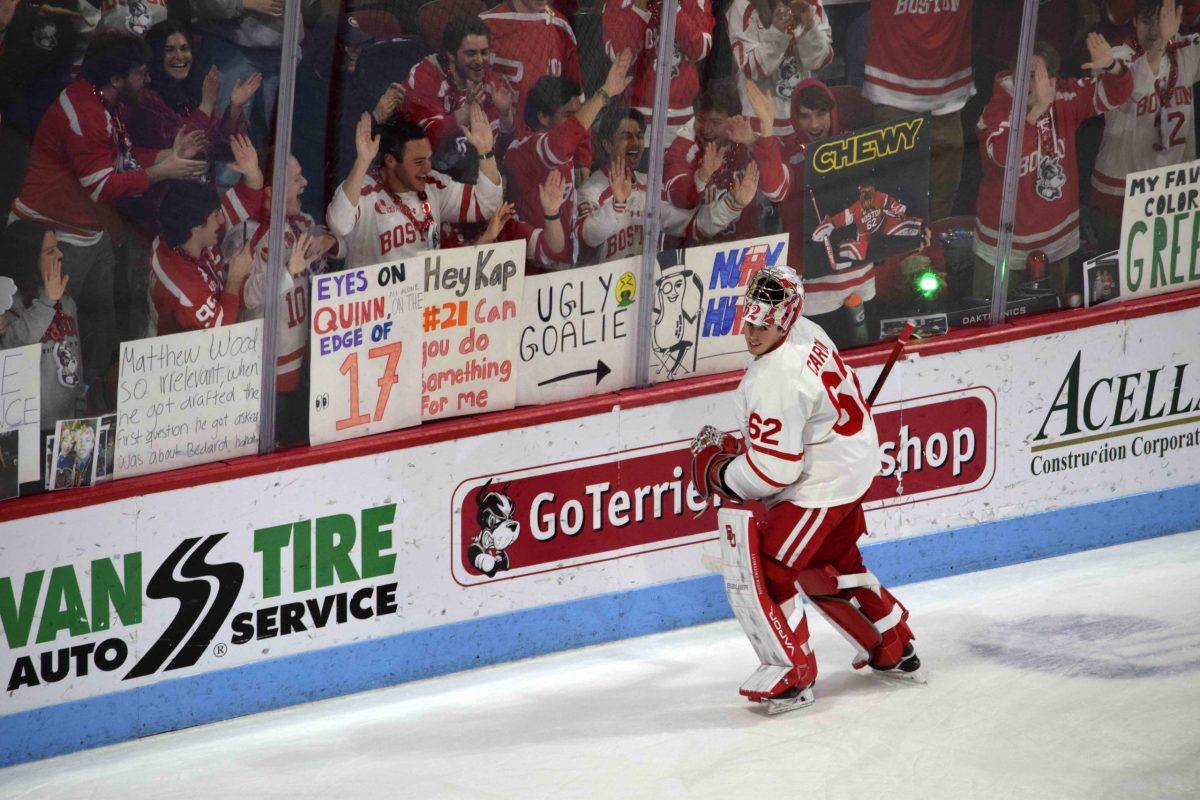 Mathieu Caron (62) celebrates with the Dog Pound after recording his second shutout of the season at Agganis Arena.